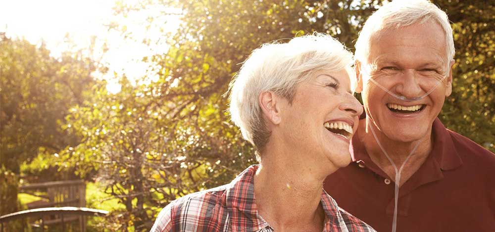 Image of a happy couple using portable oxygen concentrator